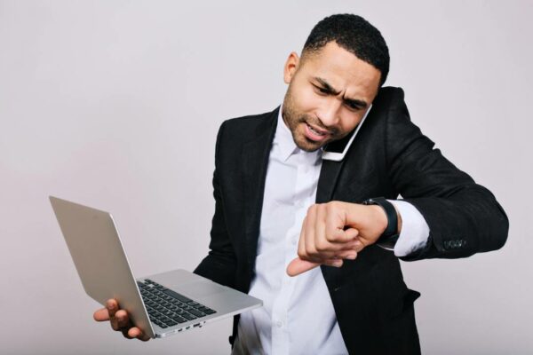 retrato-trabalhador-jovem-ocupado-na-camisa-branca-jaqueta-preta-falando-no-telefone-e-olhando-para-o-relogio-homem-de-negocios-elegante-trabalhando-com-laptop-witj-hora-de-trabalhar-reuniao